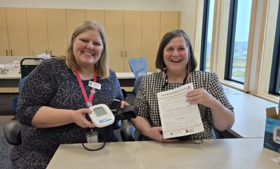 Oregon Public Library staff holding blood pressure kits