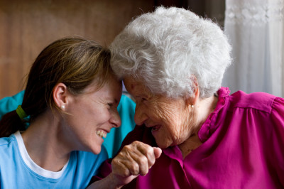 Young girl and Elderly woman laughing